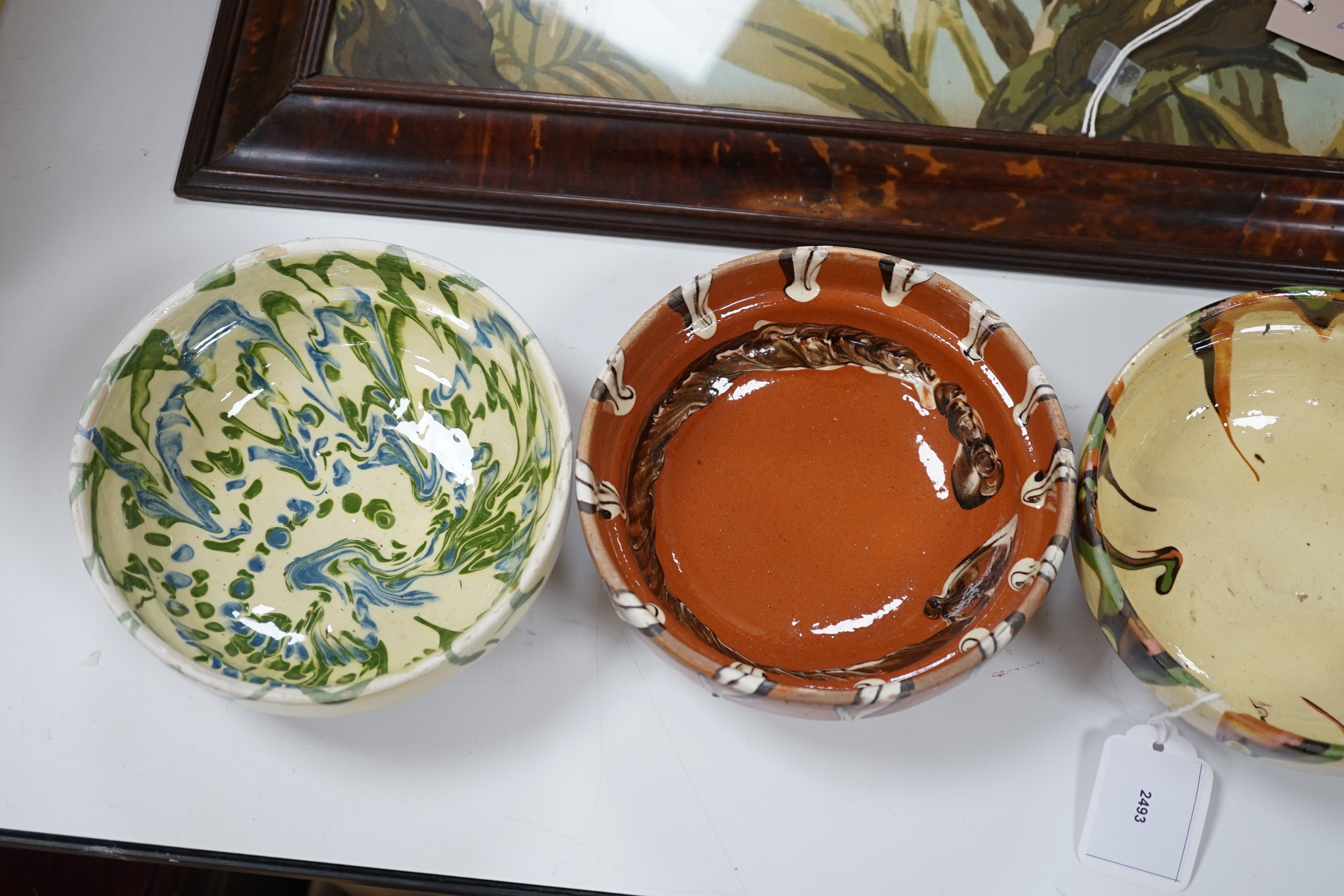 A group of six continental pottery slip decorated bowls, 16 cms diameter